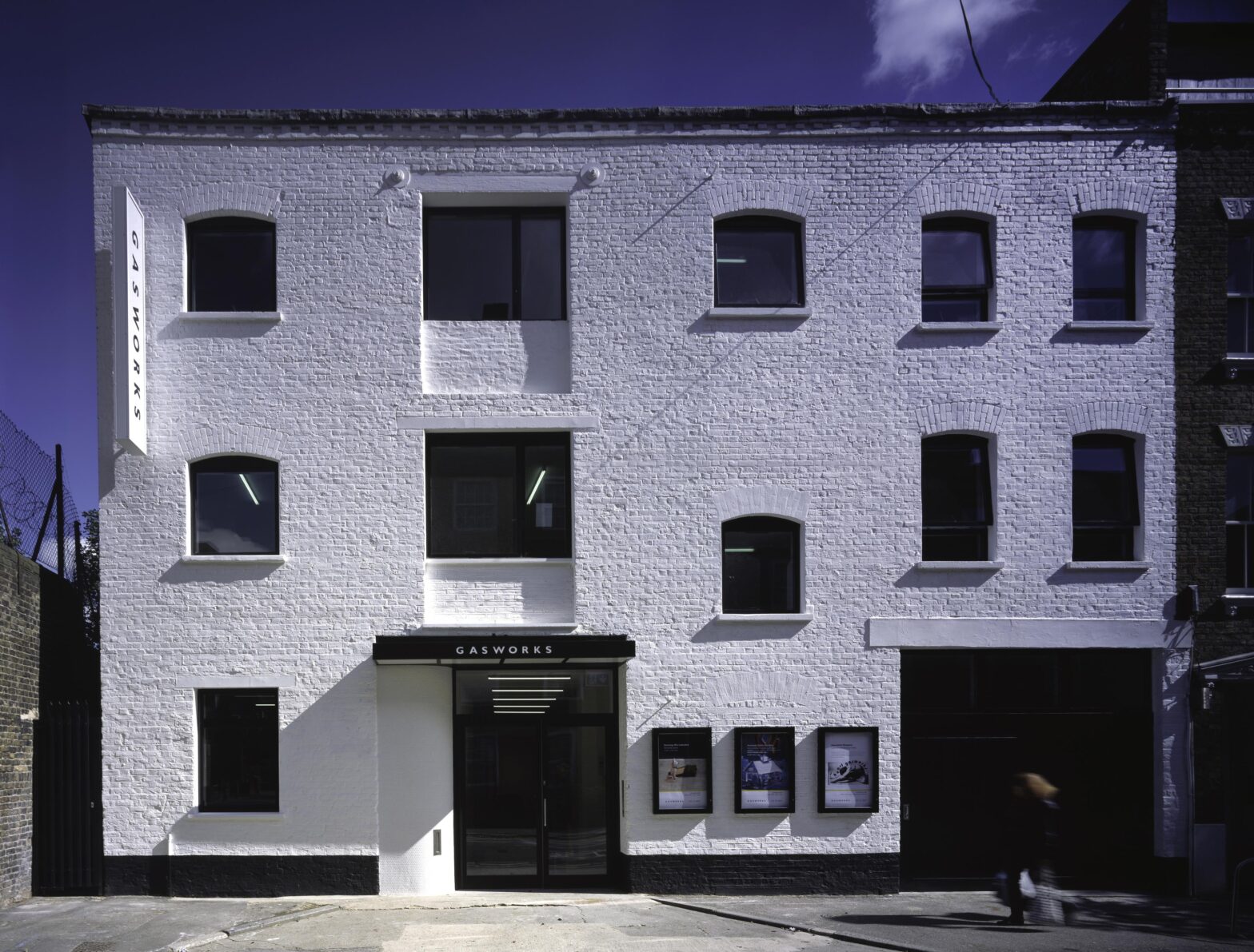 Gasworks Exterior, a 3 floor warehouse building converted for use as an art gallery and creative spaces, painted white.